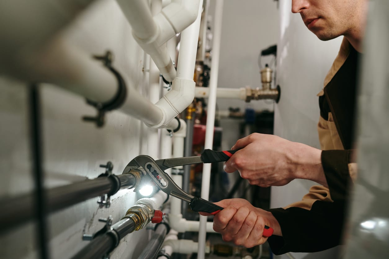 Plumbers maintaining commercial plumbing pipes in Oviedo