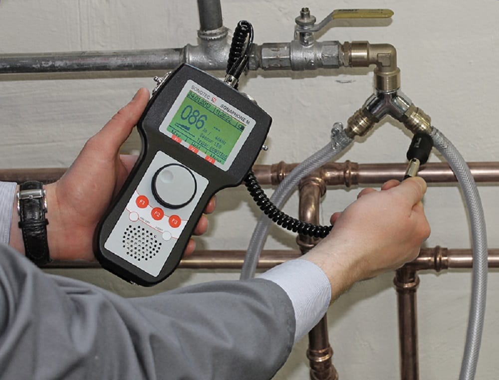Plumber testing pipes with electronic leak detection equipment in Oviedo