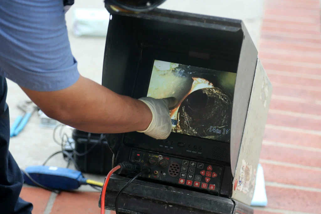 Technician viewing a drain inspection camera in Oviedo