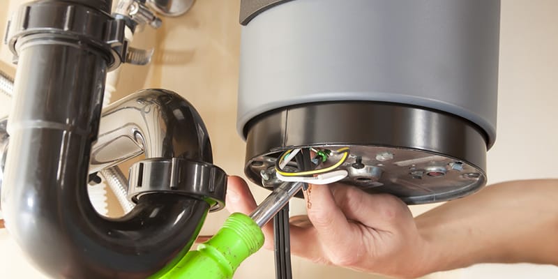 Technician repairing the heating element of a water heater in Oviedo