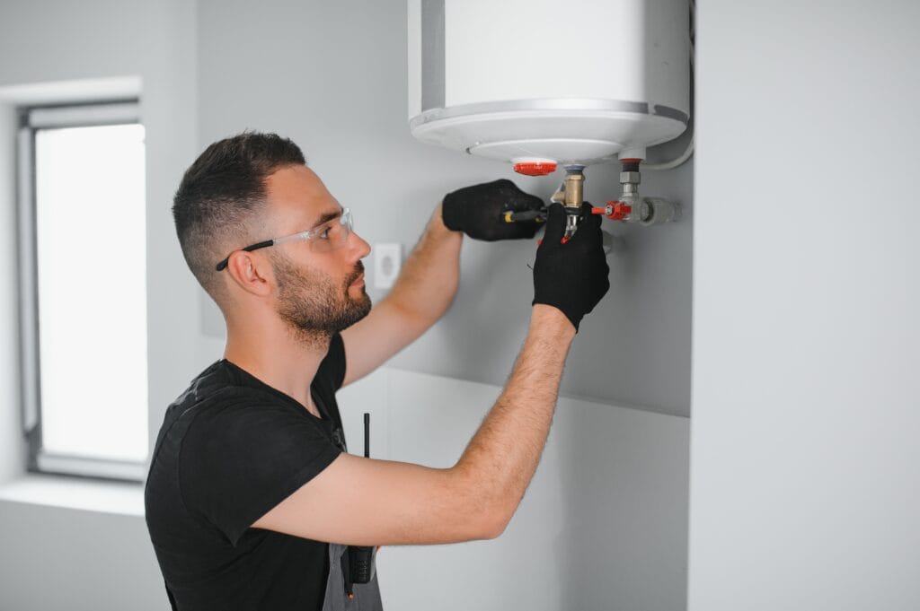 Technician performing water heater maintenance in Oviedo