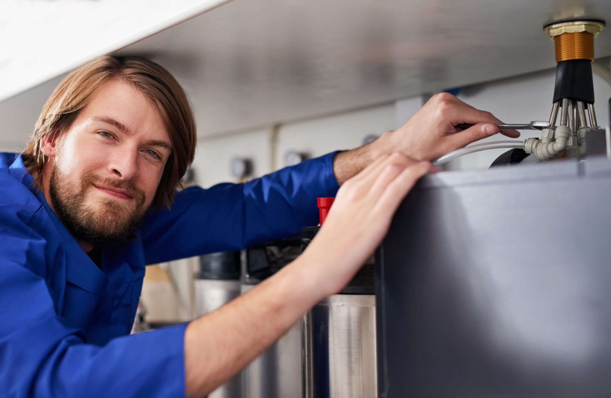 Technician servicing a residential water heater tank in Oviedo