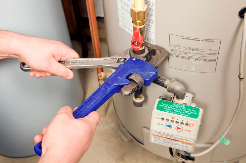 Plumber repairing a water heater valve in Oviedo